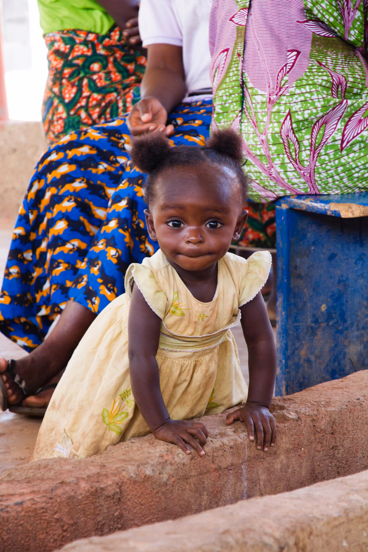 Young Haitian girl surrounded by vibrant community colors