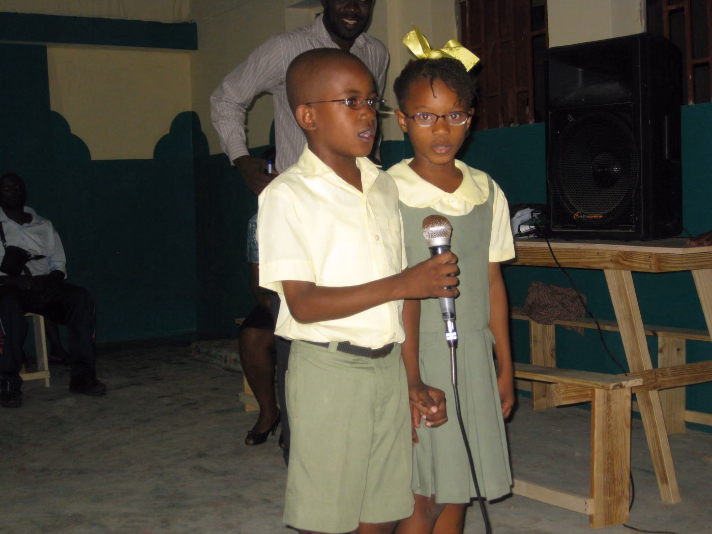 Haitian students sharing a microphone