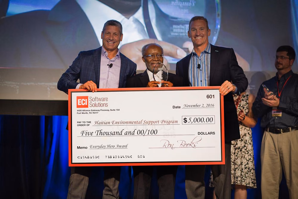 H.E.S.P. president Douglas Vaughn receives a community donation
